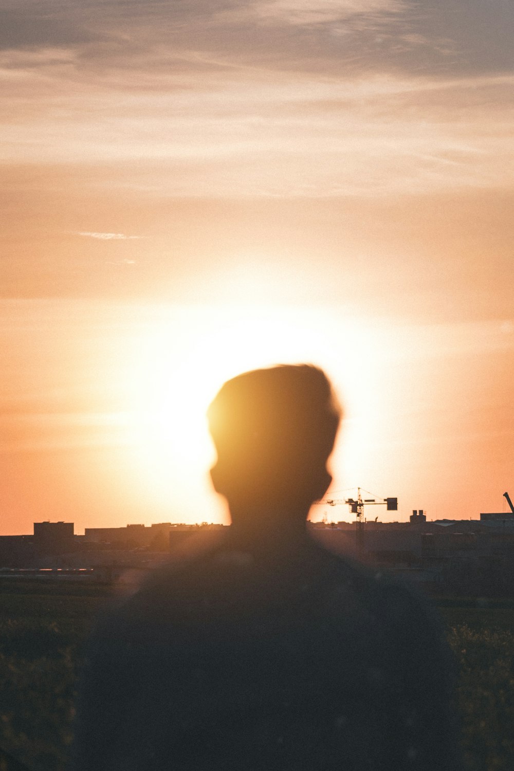 man in black jacket standing during sunset