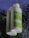 Two bottles of Simple Kind to Skin Replenishing Rich Moisturizer are shown, with water droplets on the surface, set against a dark, wet background.