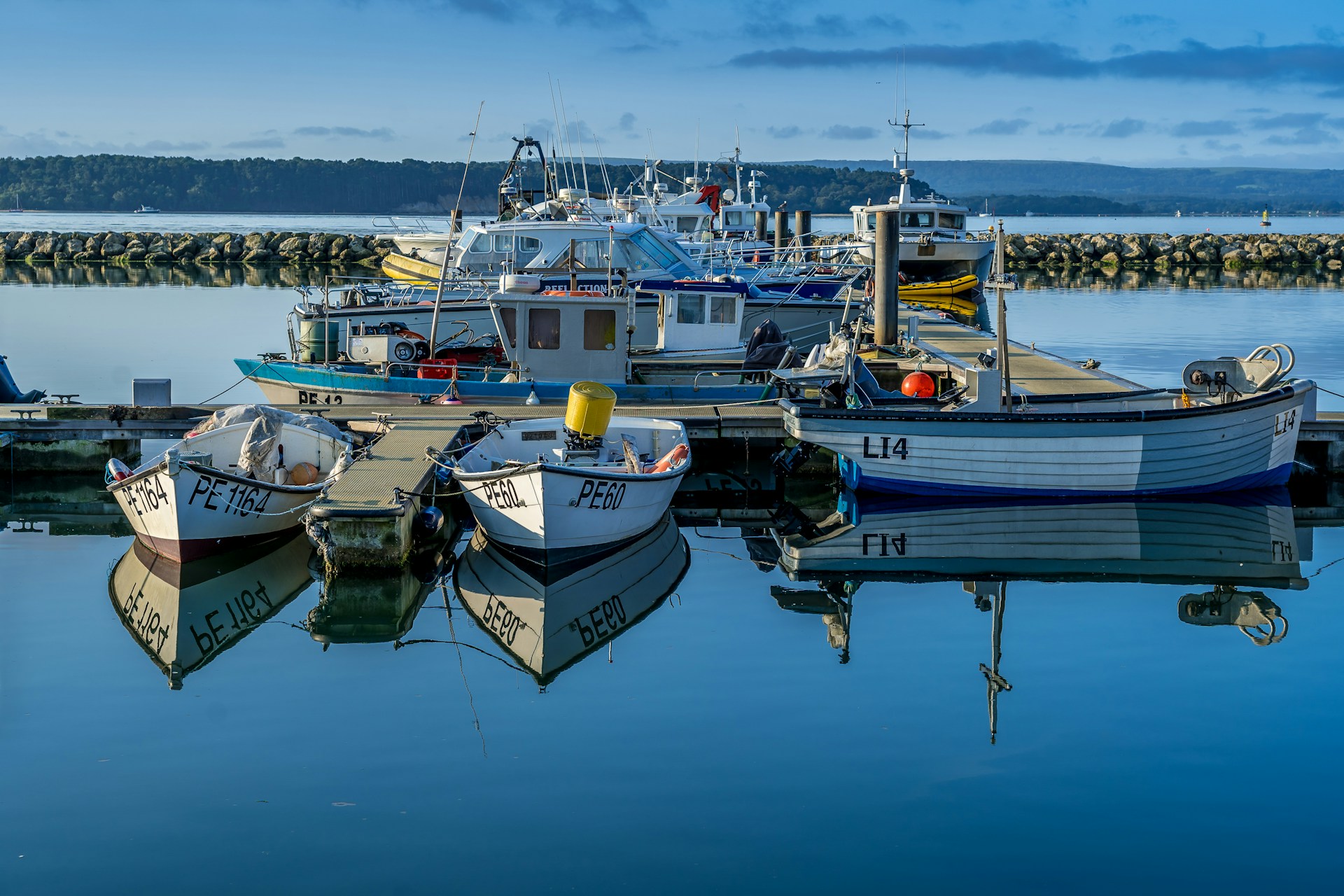 white and blue boats on sea during daytime