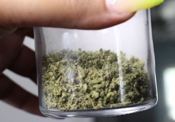 green kush in clear glass container