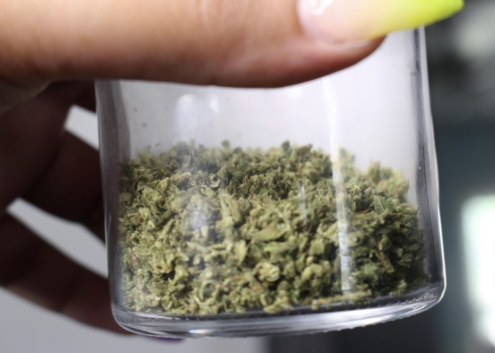 green kush in clear glass container