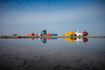 Brightly colored pedal boats lined up ready for a sunny day adventure.