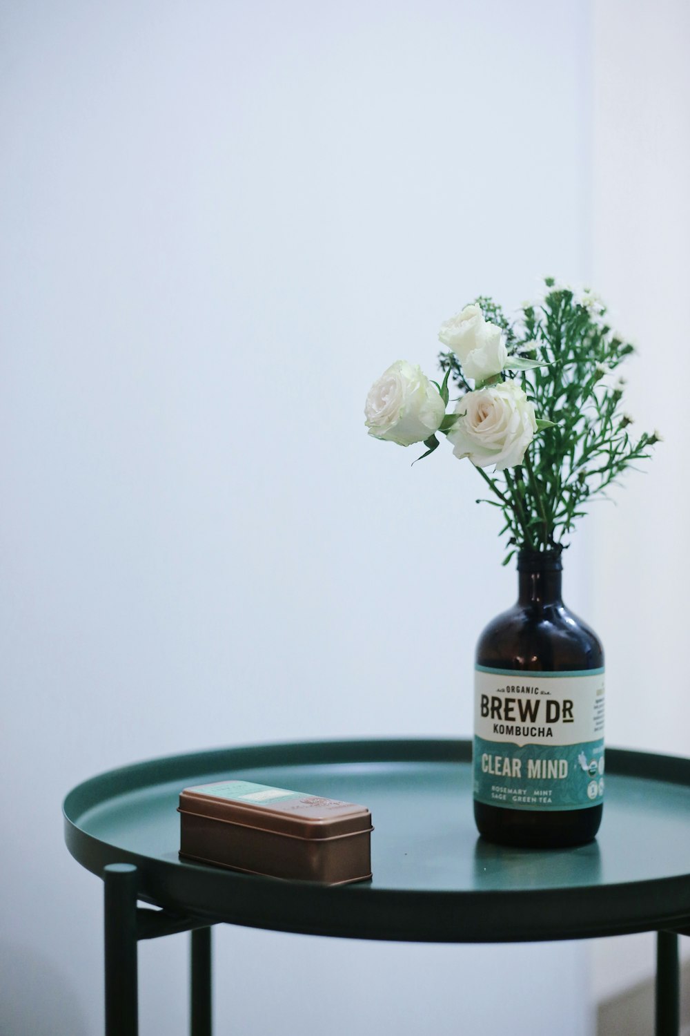 white roses in vase on table