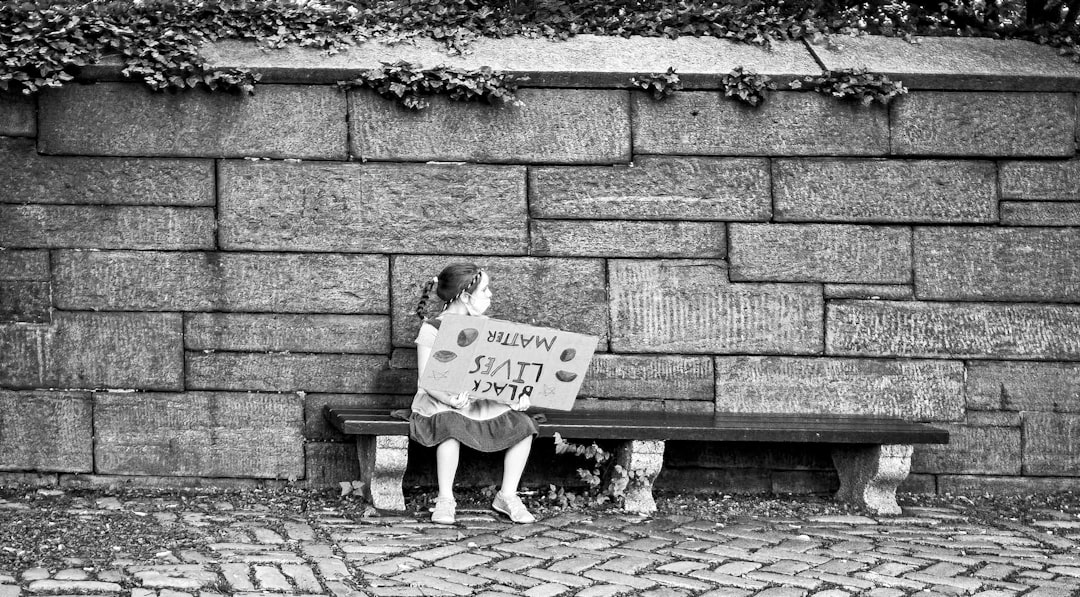 man and woman sitting on bench