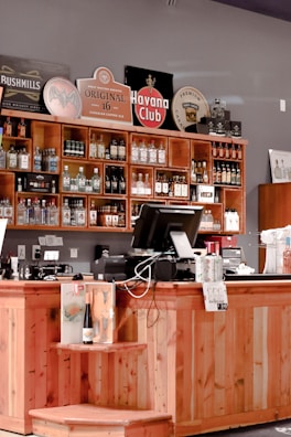 A beautifully arranged display of various alcoholic and non-alcoholic beverages on a wooden counter.