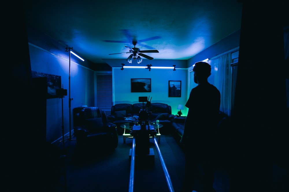 silhouette of man standing near table and chairs