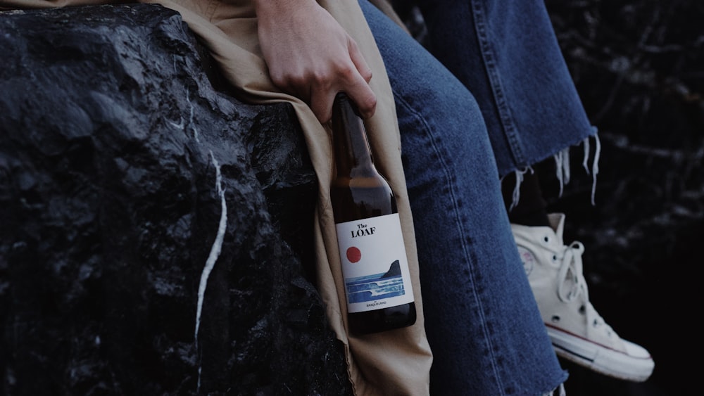 person holding white labeled bottle