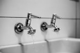 stainless steel shower head in white bathtub