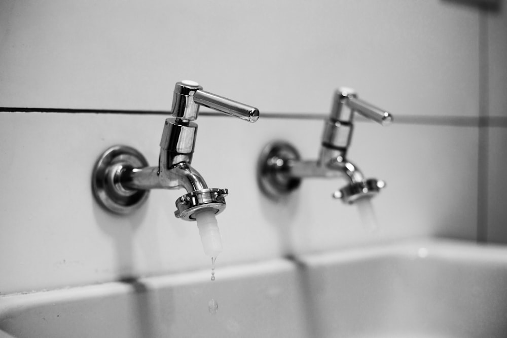 stainless steel shower head in white bathtub