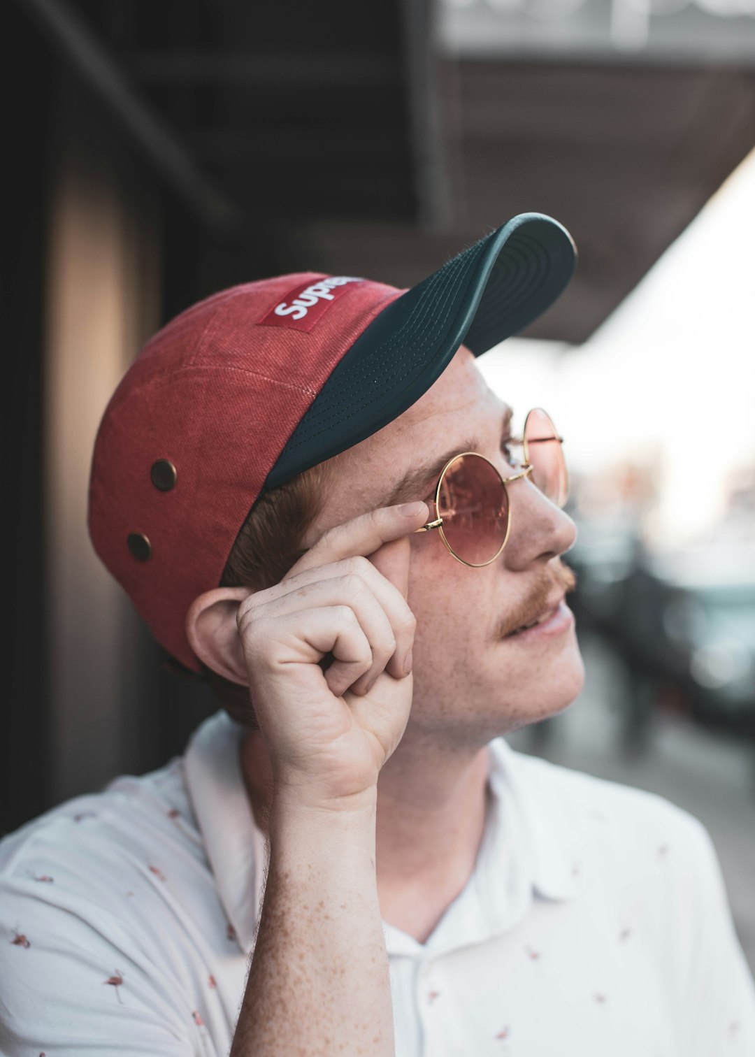 man in white shirt wearing sunglasses and red cap