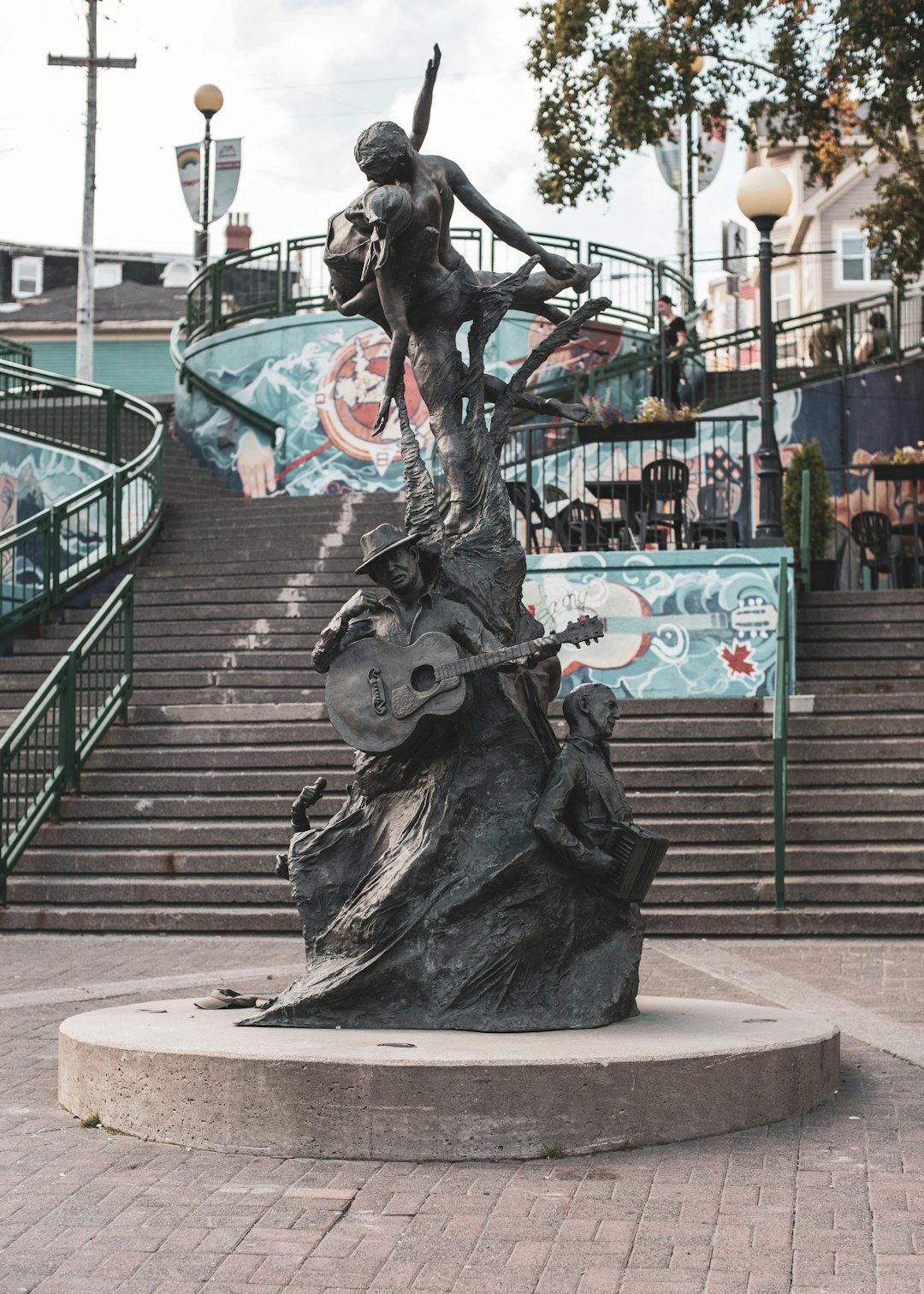 black statue of man riding horse near green metal fence during daytime