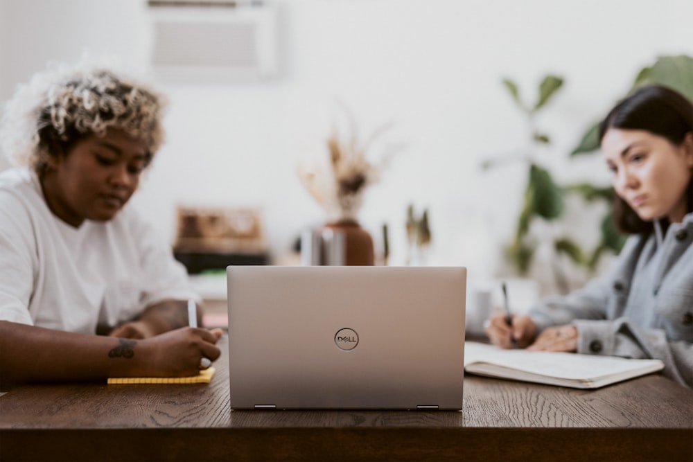 man in white dress shirt using laptop