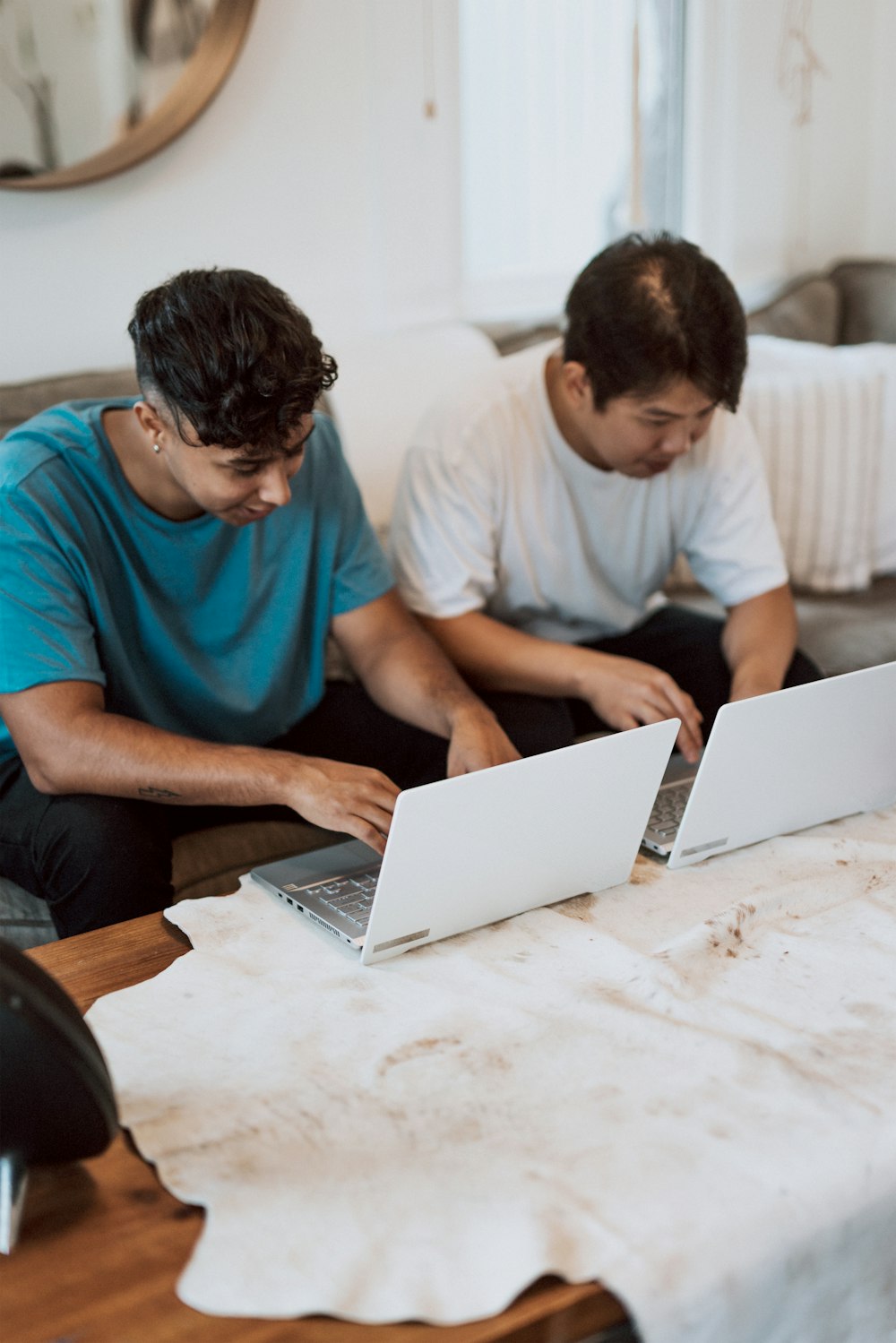 man in blue crew neck t-shirt using laptop