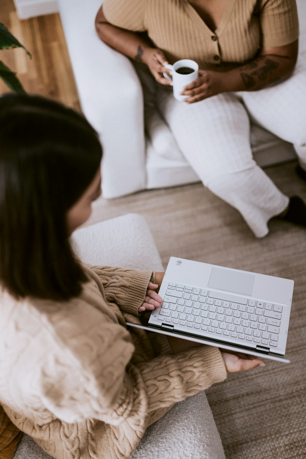 woman in white long sleeve shirt sitting on white couch