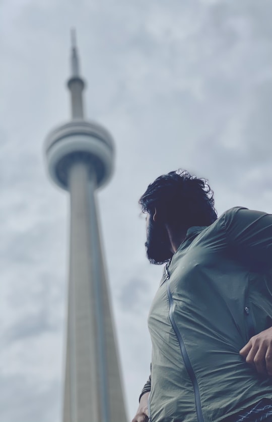 man in white shirt looking at tower in Roundhouse Park Canada