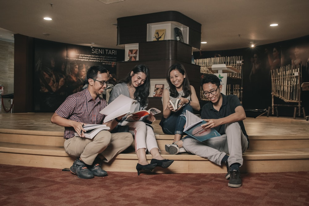 group of people sitting on brown wooden bench