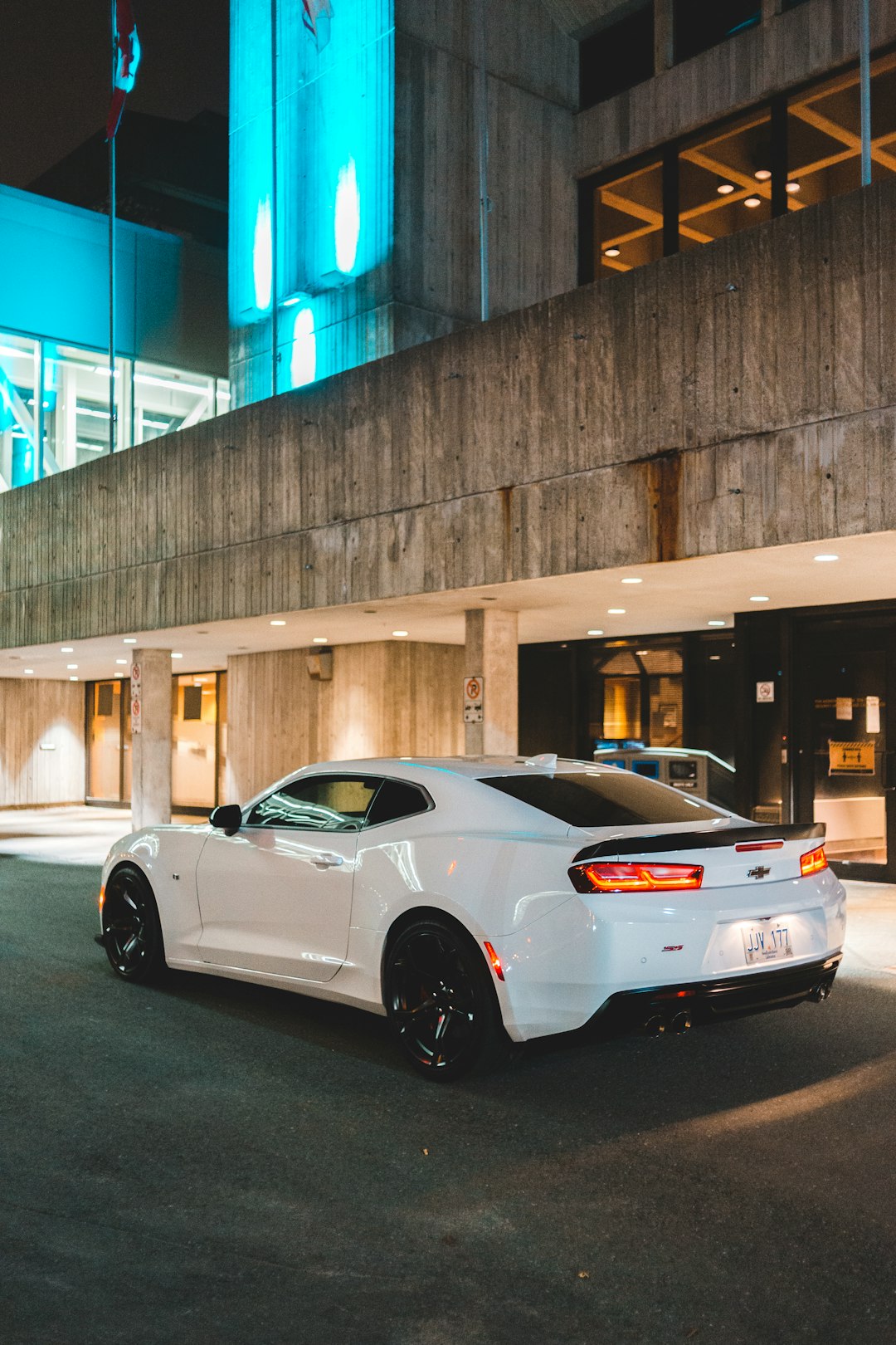 white coupe parked on parking lot during night time