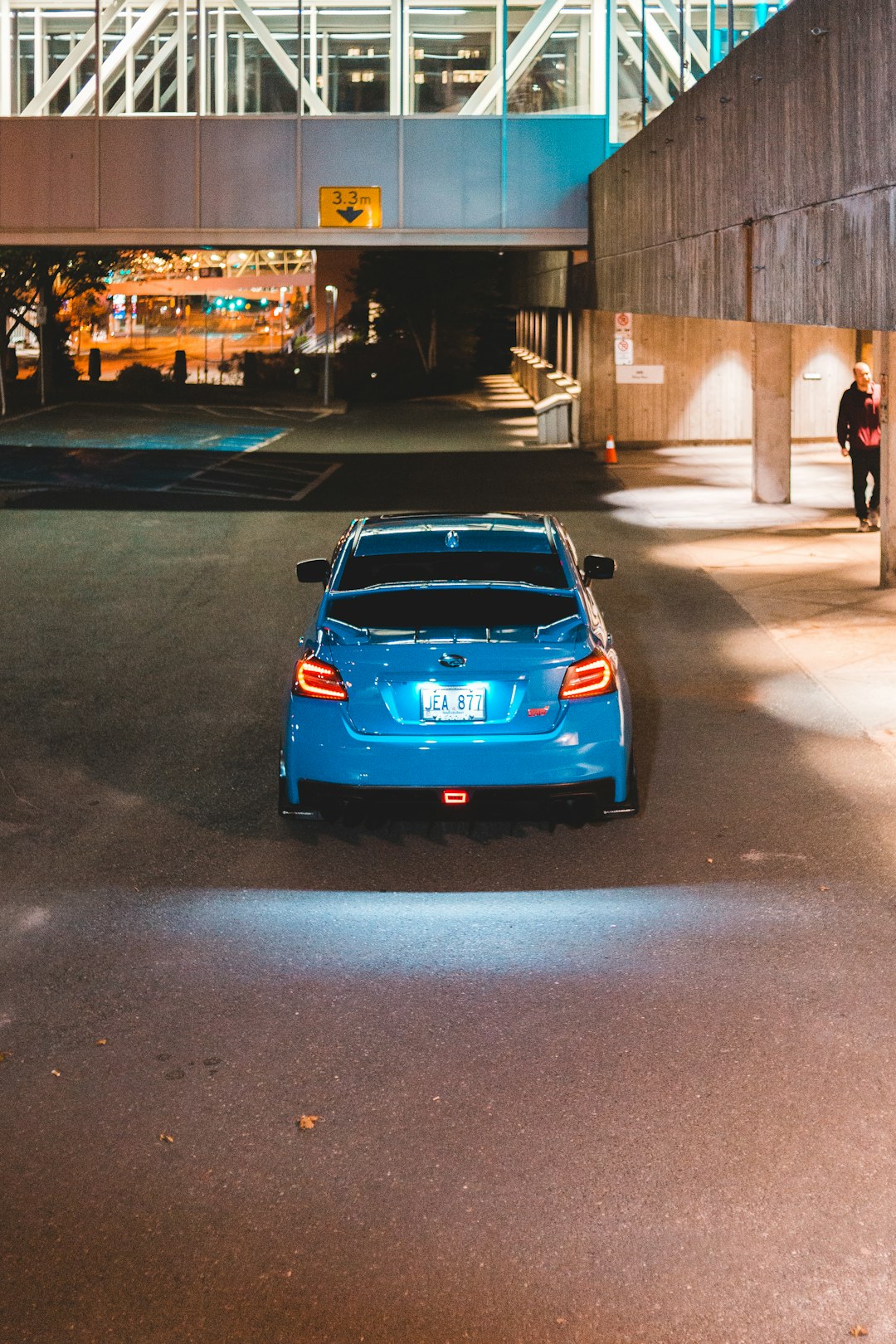 blue porsche 911 parked on street during night time