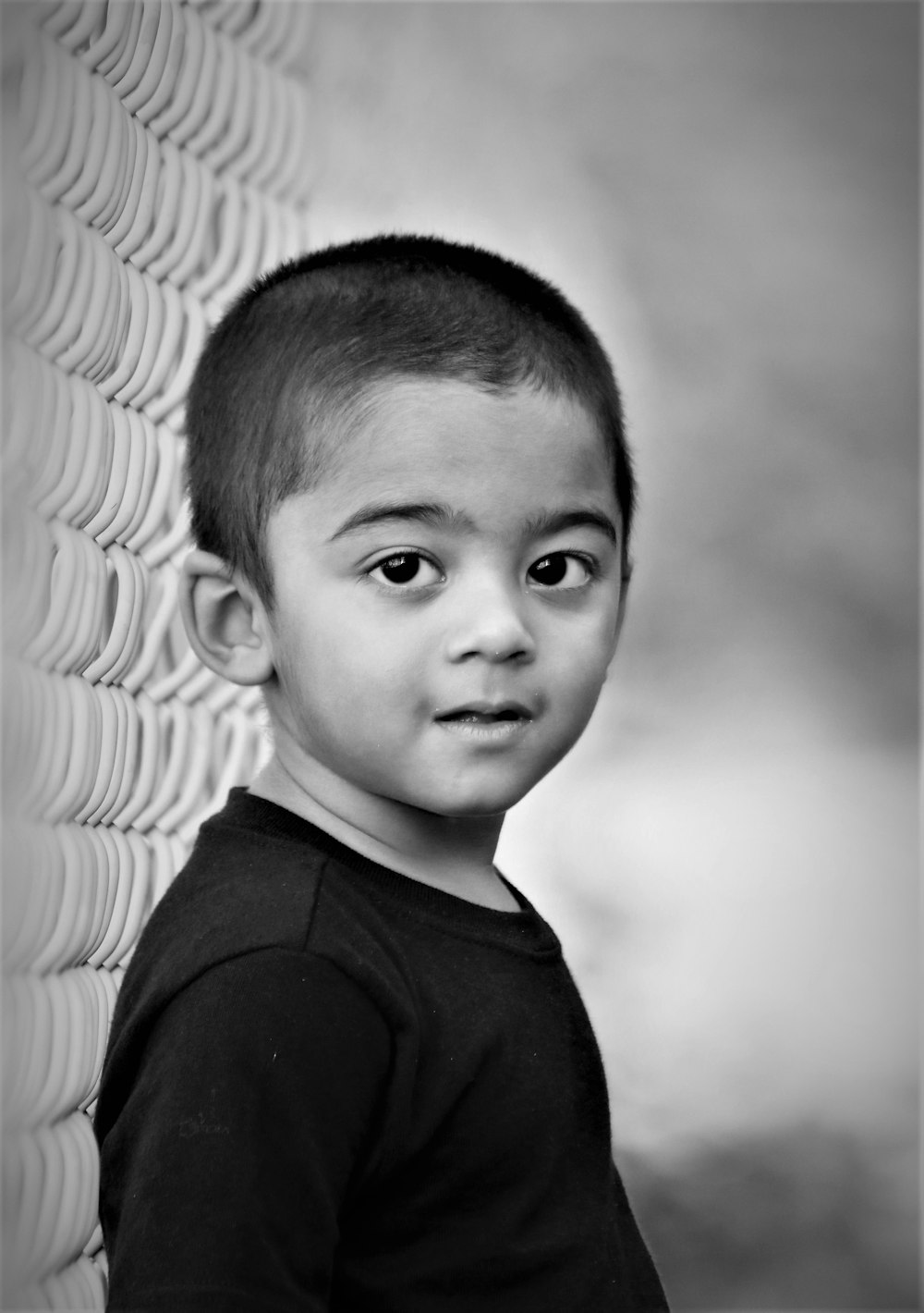 grayscale photo of boy in crew neck shirt