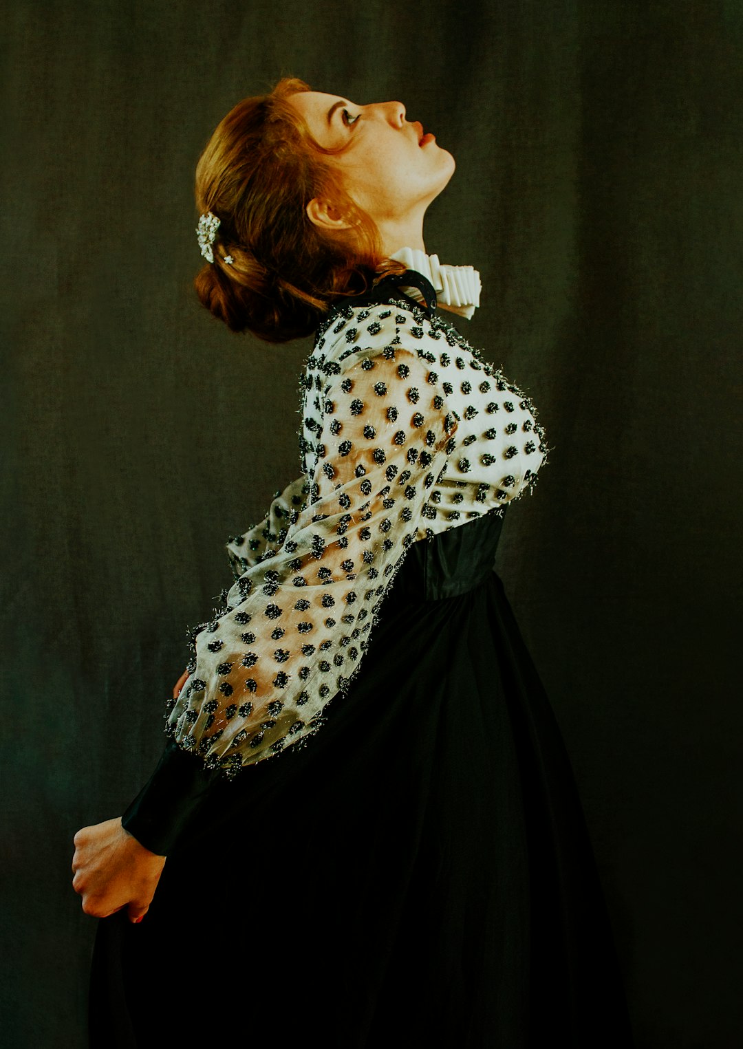 woman in white and black polka dot long sleeve shirt and black skirt