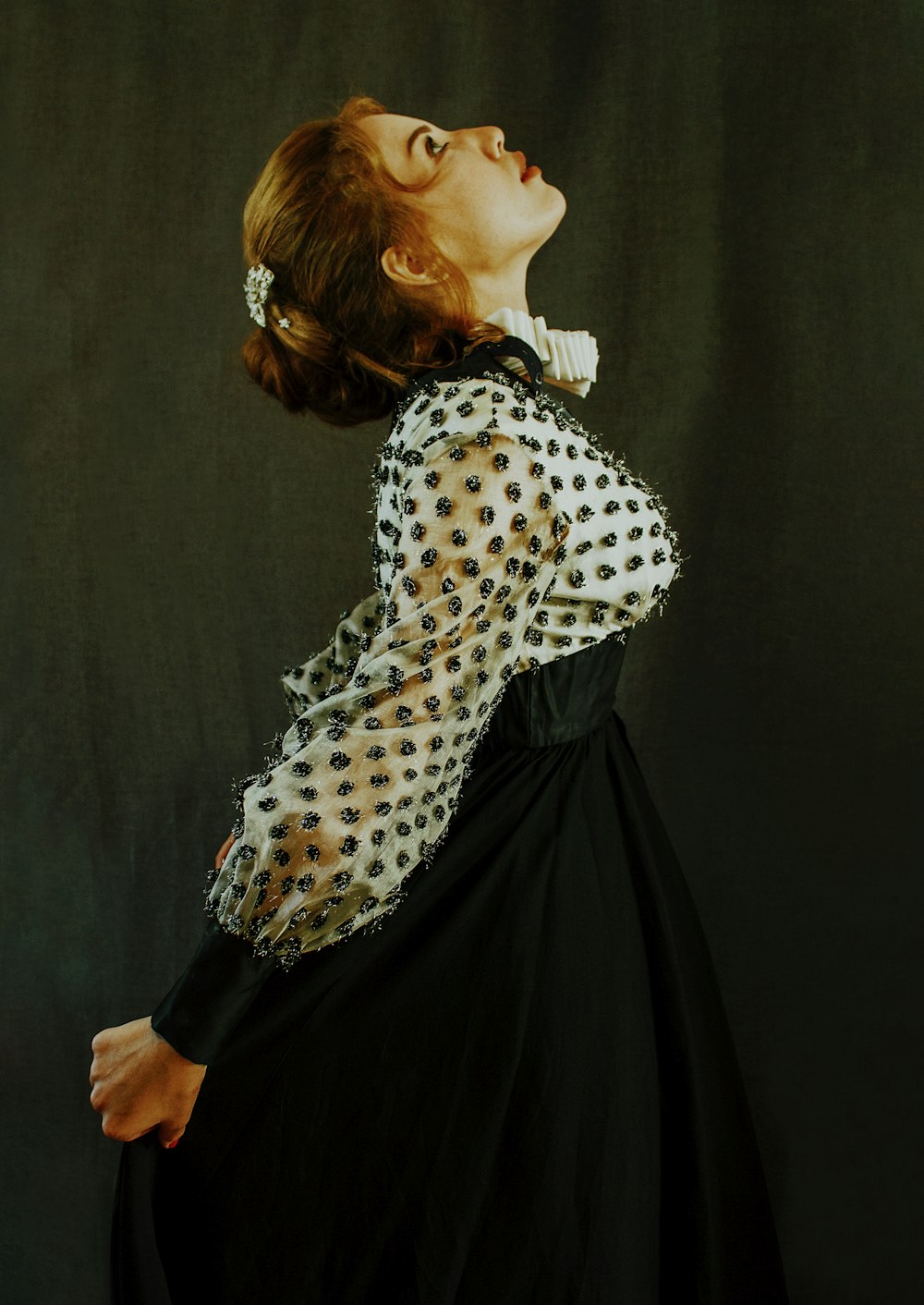 woman in white and black polka dot long sleeve shirt and black skirt