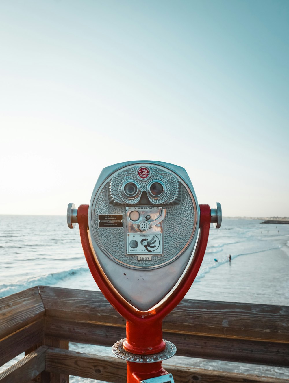 red and gray coin operated binoculars