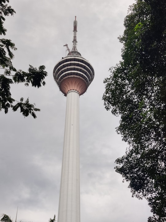 white concrete tower under white clouds during daytime in KL Tower Malaysia