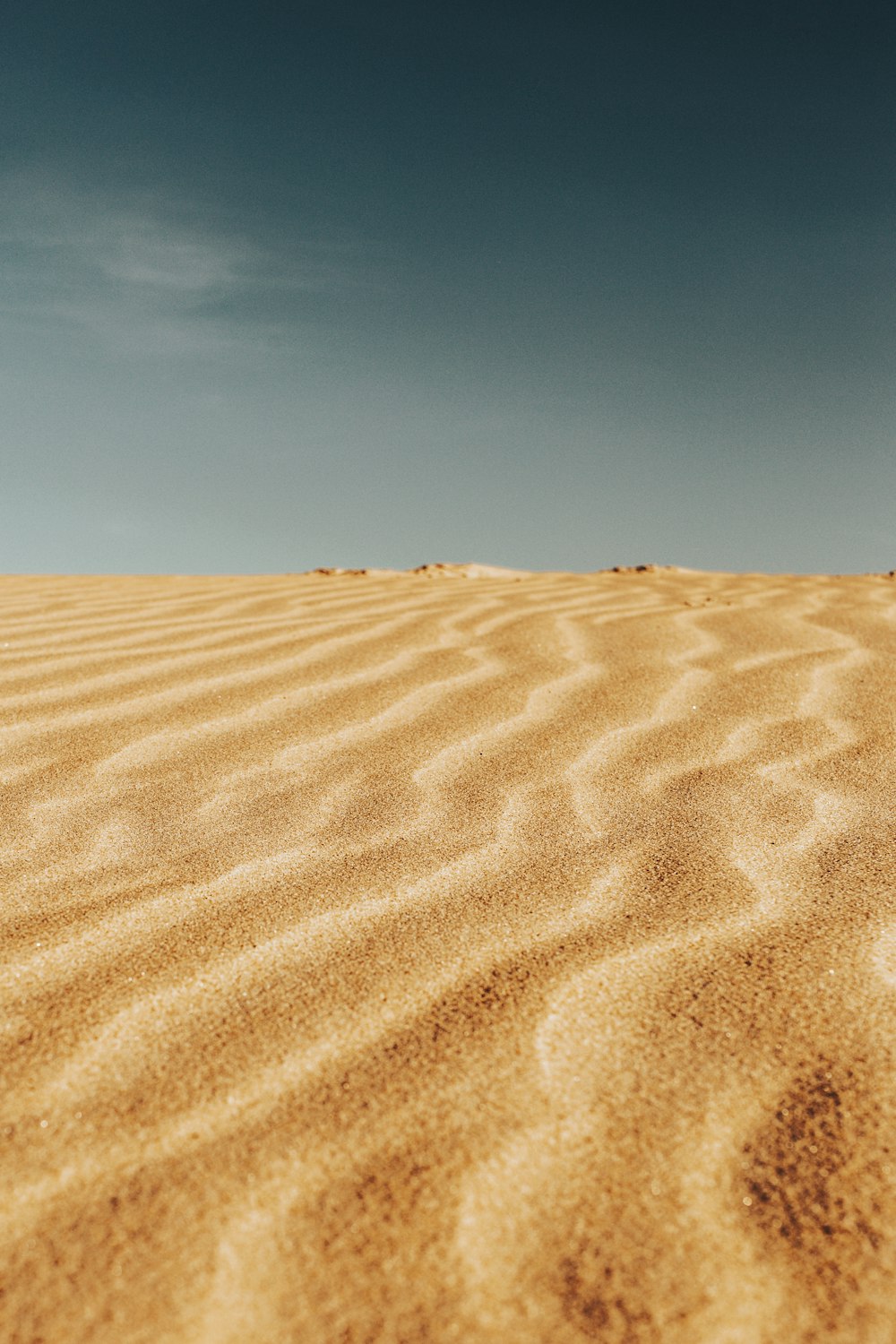 brown sand under blue sky during daytime