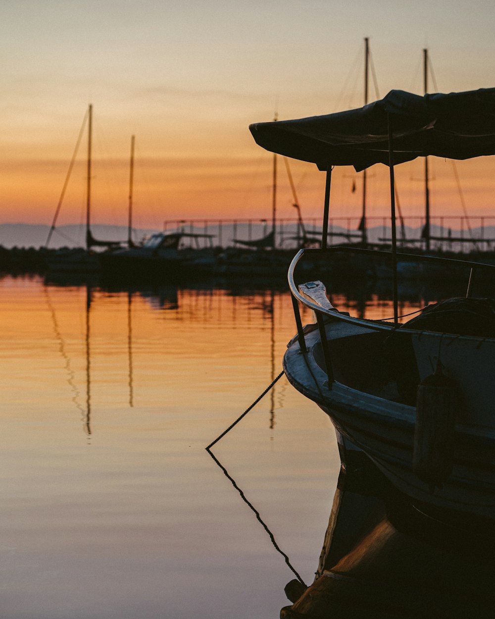 blue and brown boat on water during sunset