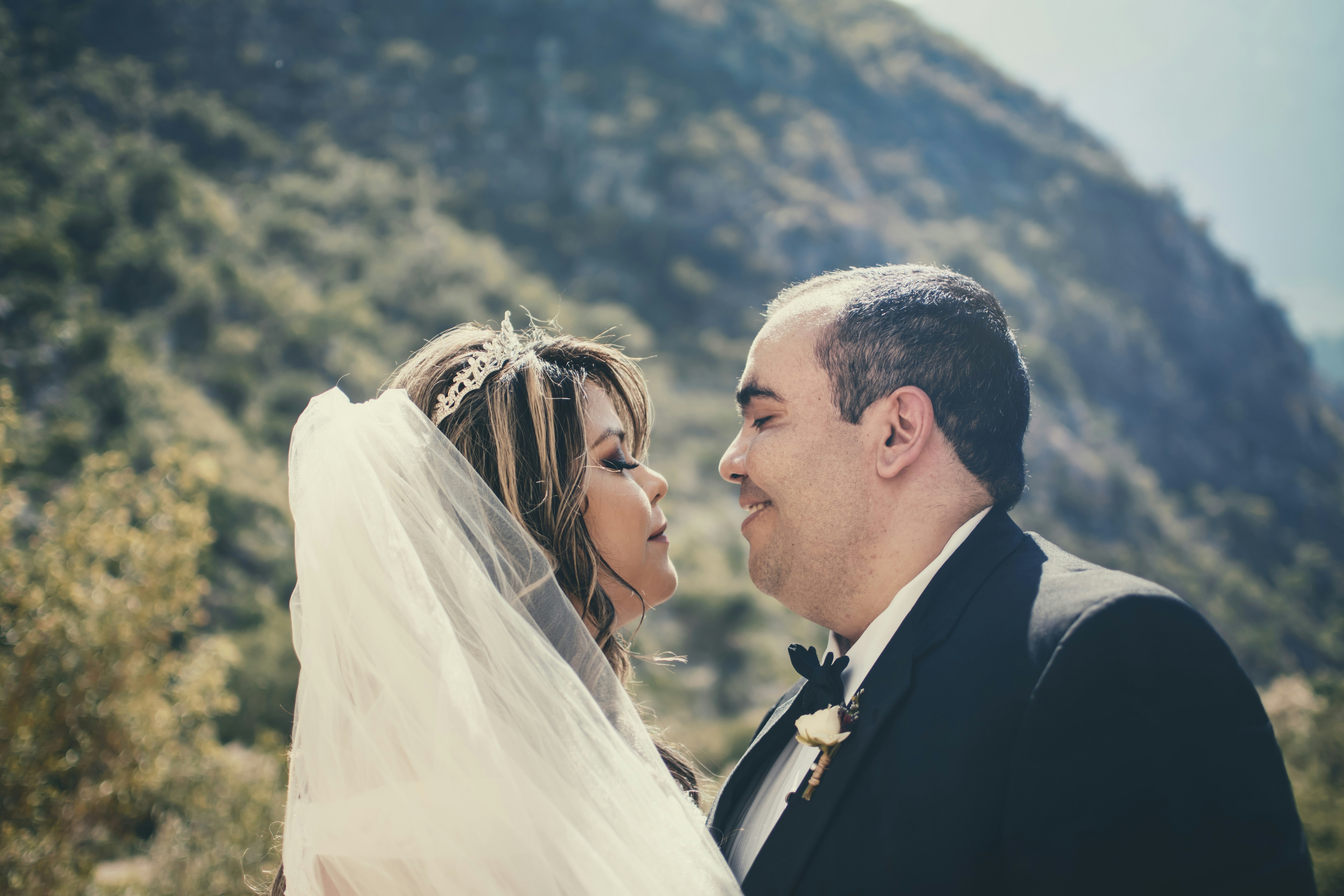 Man in black suit kissing woman in white wedding dress photo – Free ...