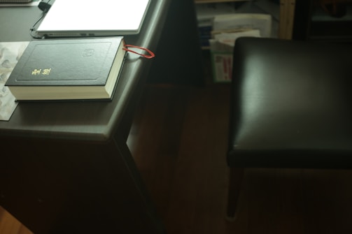 Close-up of legal books and documents with navy and gold accents on a desk.