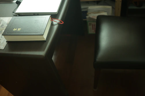 Close-up of legal books and documents on a polished wooden desk, symbolizing expertise.