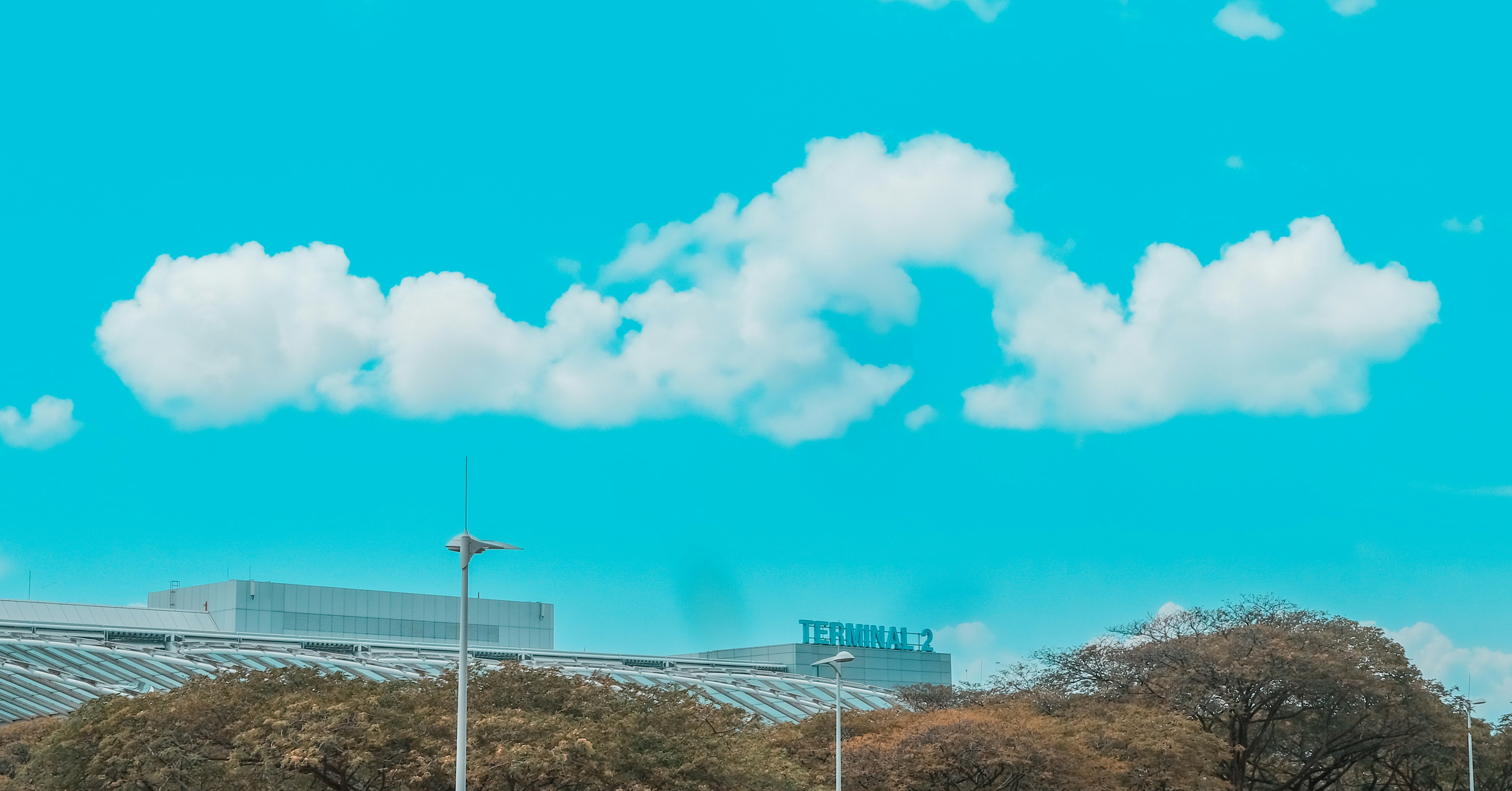 white clouds over white and blue building