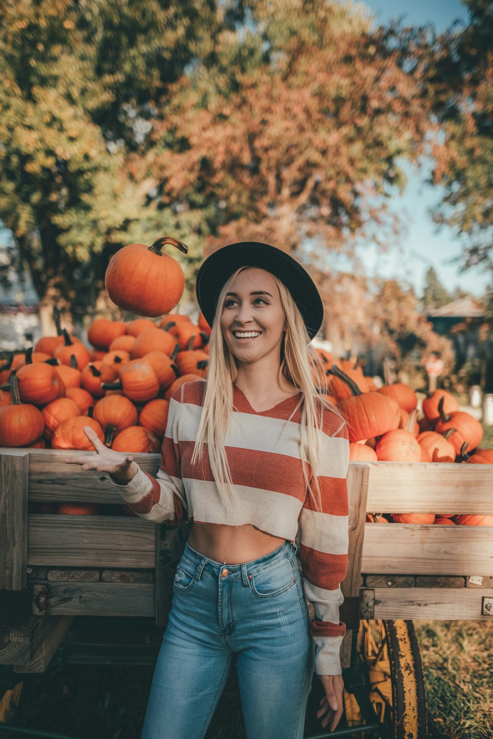 woman in red and white striped long sleeve shirt and blue denim jeans standing in front