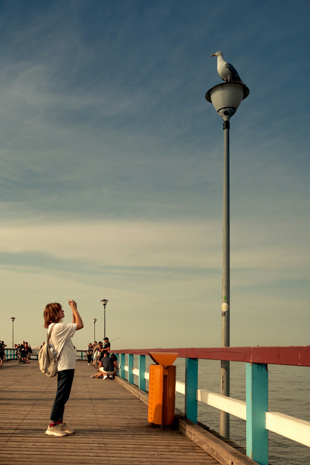 man and woman standing on dock during daytime