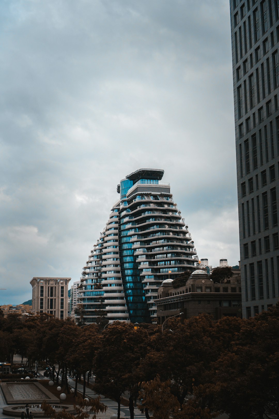 white and blue concrete building under cloudy sky during daytime