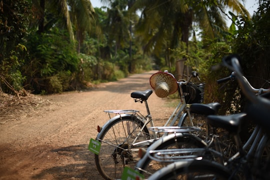black and gray bicycle on brown dirt road during daytime in Battambang Province Cambodia