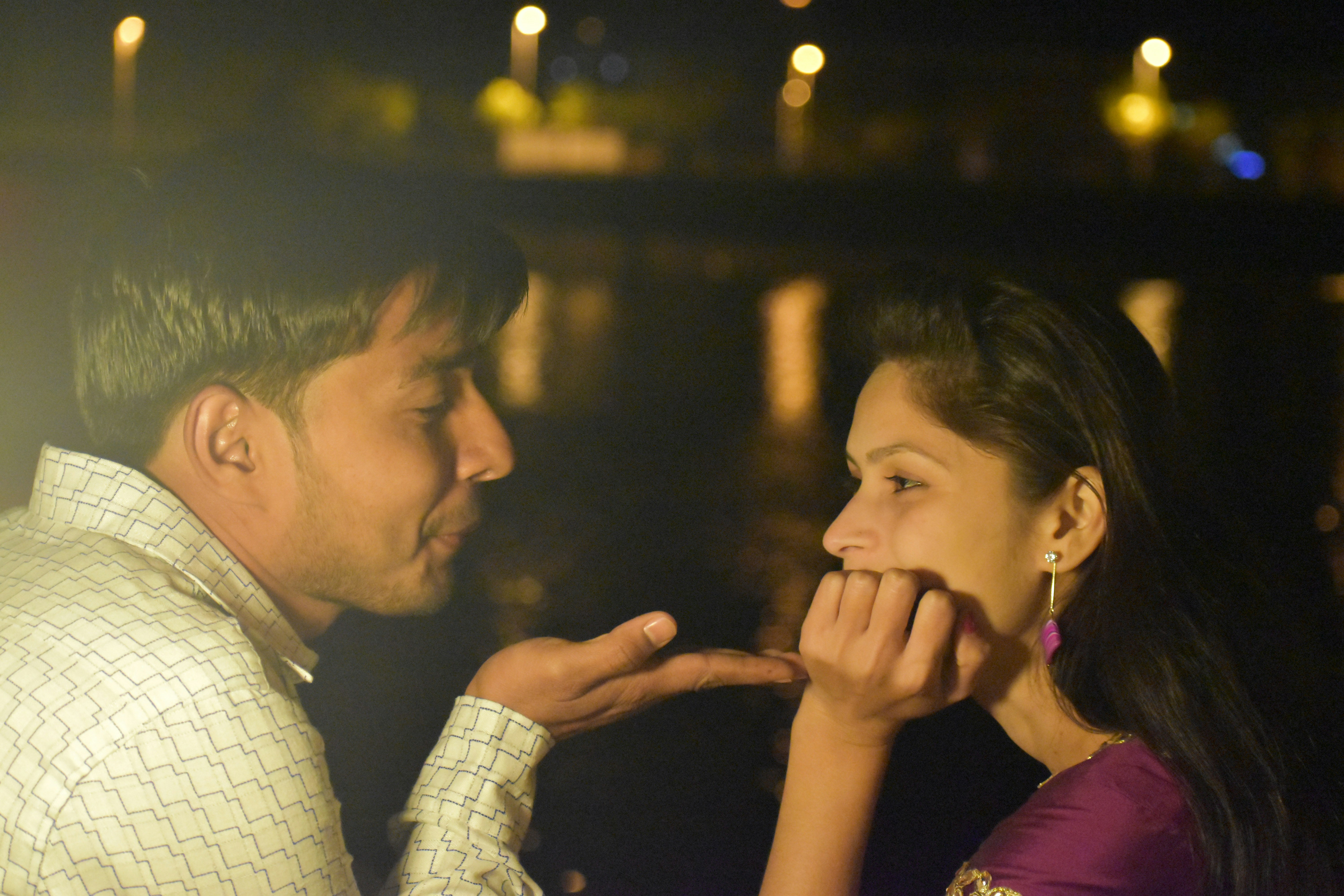 man in white and black checkered dress shirt kissing womans cheek