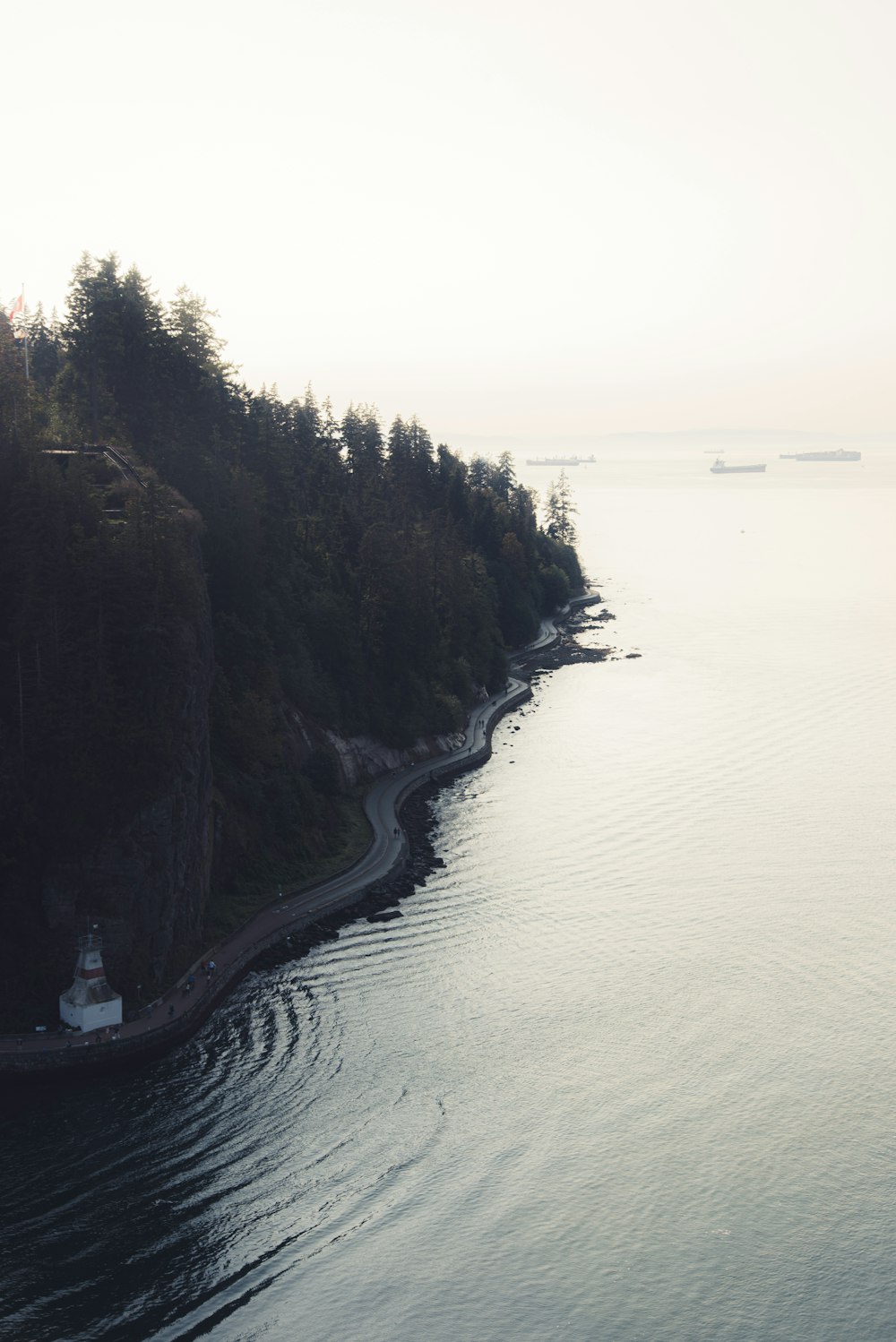 body of water near mountain during daytime