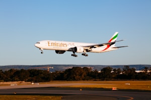 white and red passenger plane in the sky during daytime
