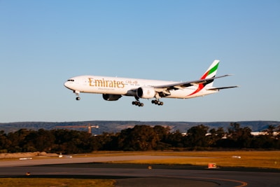 white and red passenger plane in the sky during daytime