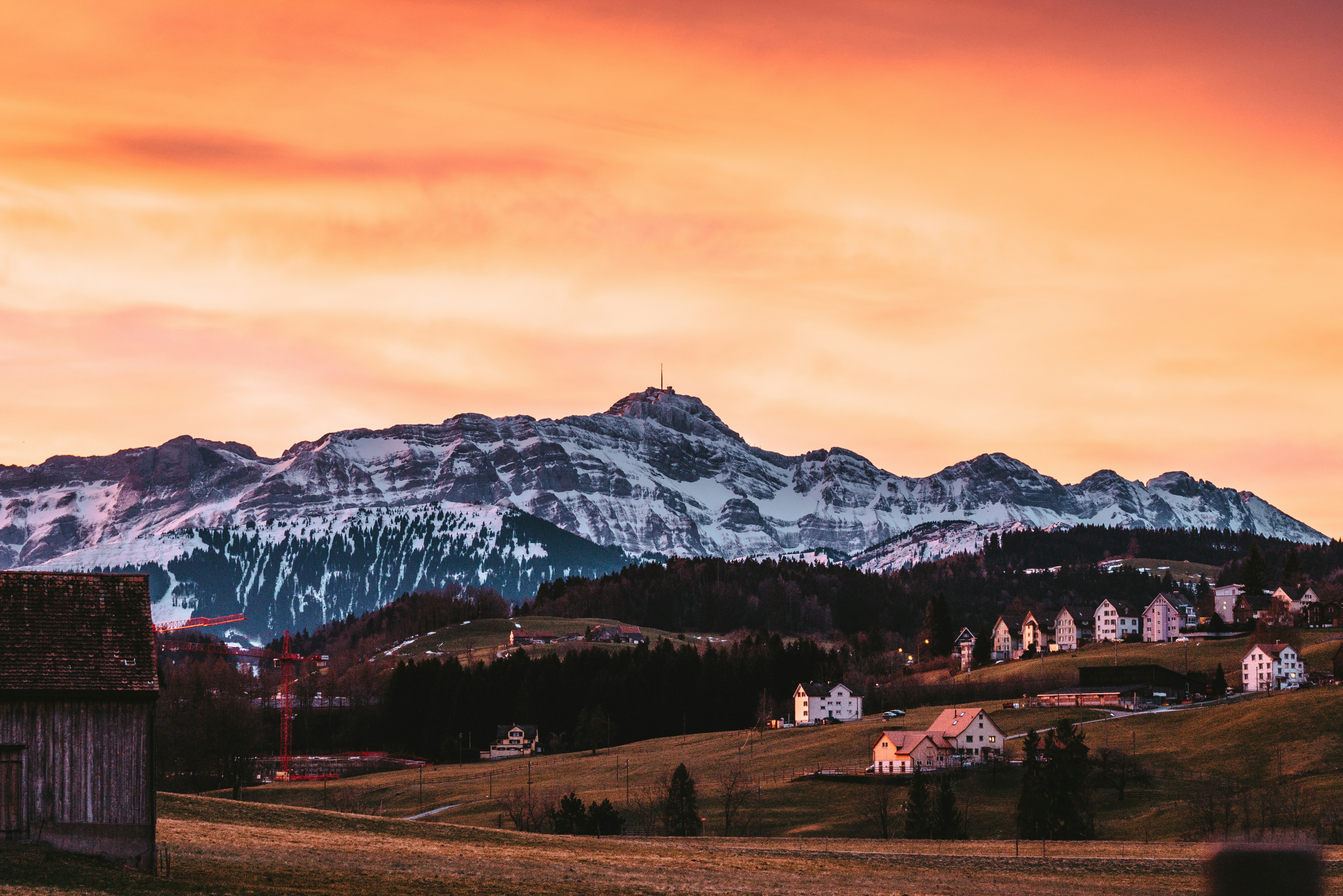 white and brown mountains under orange sky