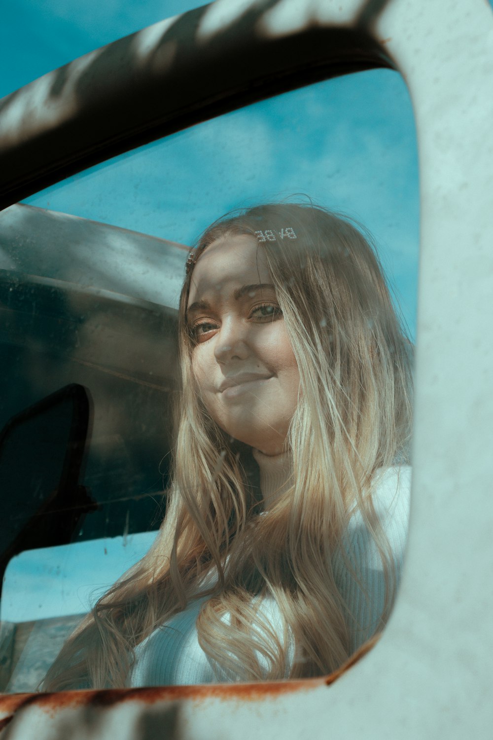 woman in white shirt in car