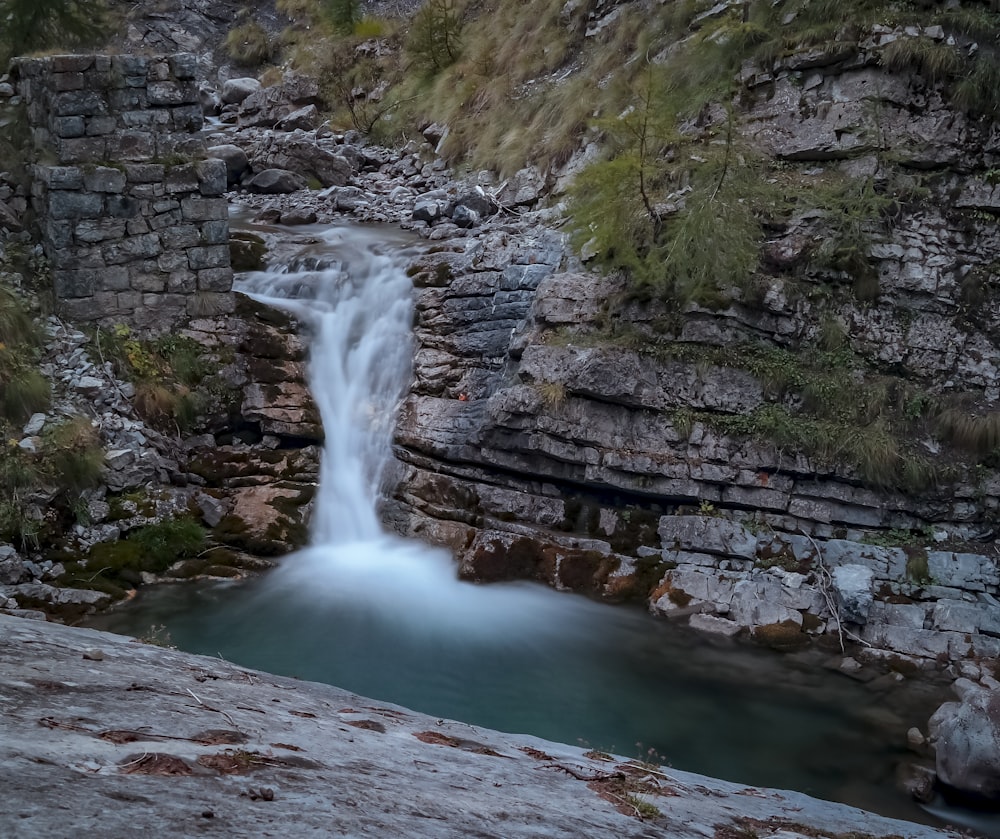 waterfalls between rocky mountain during daytime