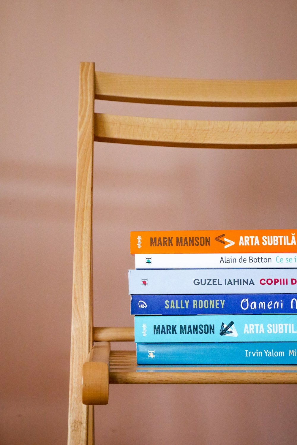 books on brown wooden shelf