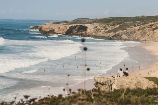 people on beach during daytime in Aljezur Portugal