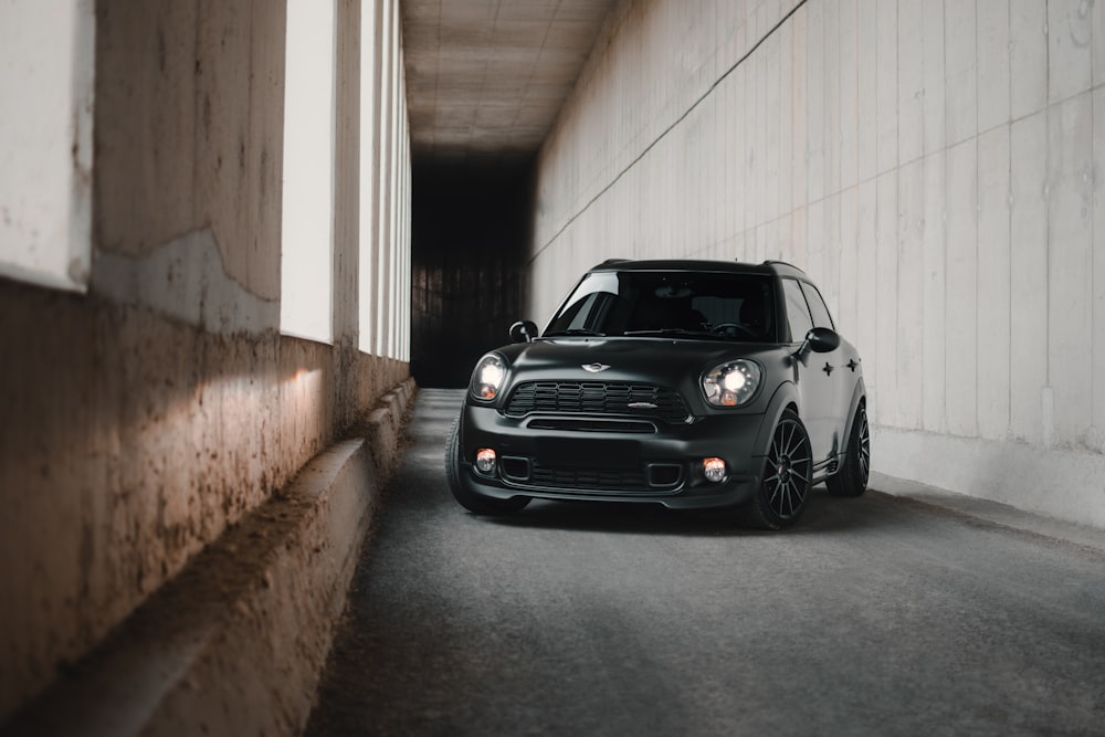 a small black car parked in a tunnel