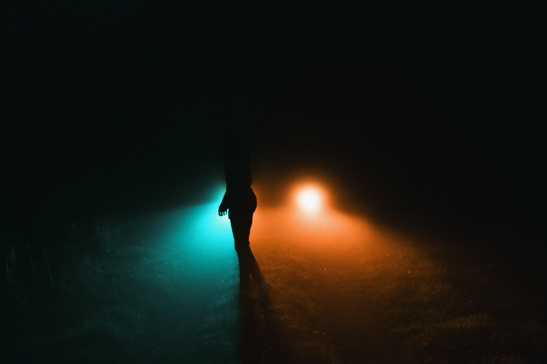 person walking on a dark room