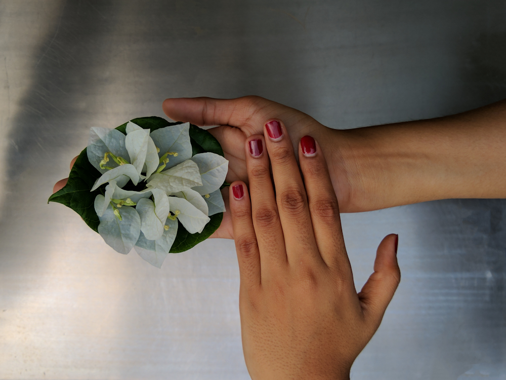 person holding white flower bouquet