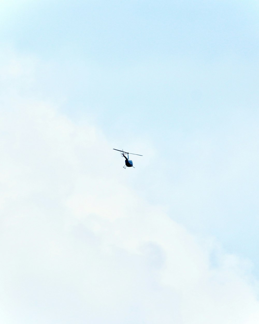 black airplane flying in the sky during daytime